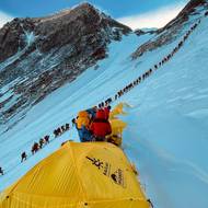 Na jednom ze starších snímků je vidět dlouhá fronta horolezců, kteří stoupají na vrchol.