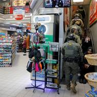 Podle prezidenta jsou federální agenti v Minnesotě, aby odvezli „odsouzené vrahy, drogový dealery a závislé, násilníky, propuštěné a uprchlé vězně, nebezpečné osoby z cizích psychiatrických léčeben a blázinců a další smrtící zločince“.

(Agenti ICE stoupají po schodech v obchodě, 8. ledna.)