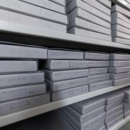 Fotografie jsou uloženy v krabicích a obálkách, které zabrání další degradaci materiálu. 