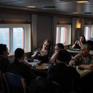 Pasažéři v jídelně lodi si povídají, hrají karty či pletou. „Známe se. Mluvíme o rodině, přátelích, svatbách,“ řekla šedesátiletá Karen Rasmussenová. (14. března)